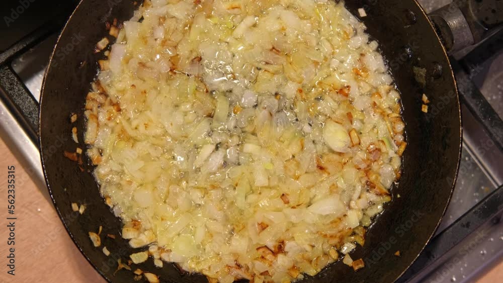 Crispy Fried Onion Bits with oil in the pan. Deep fried onion. Homemade