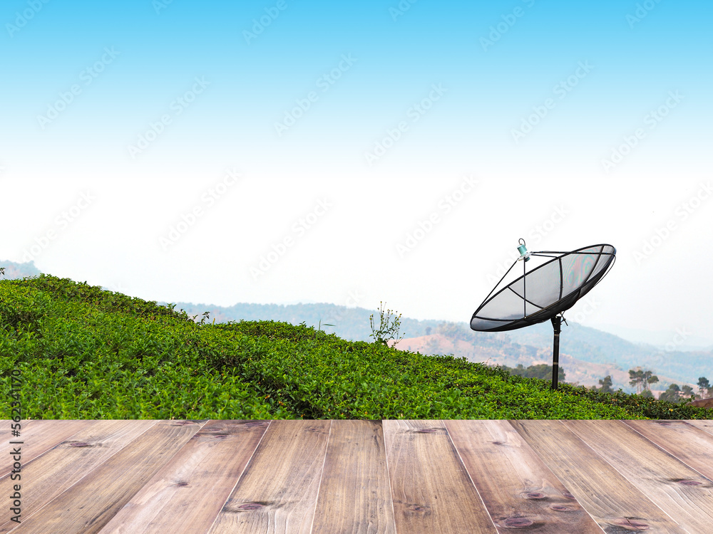 Wooden table top over satellite dish in green tea farm Wooden table top over satellite dish in green tea farm