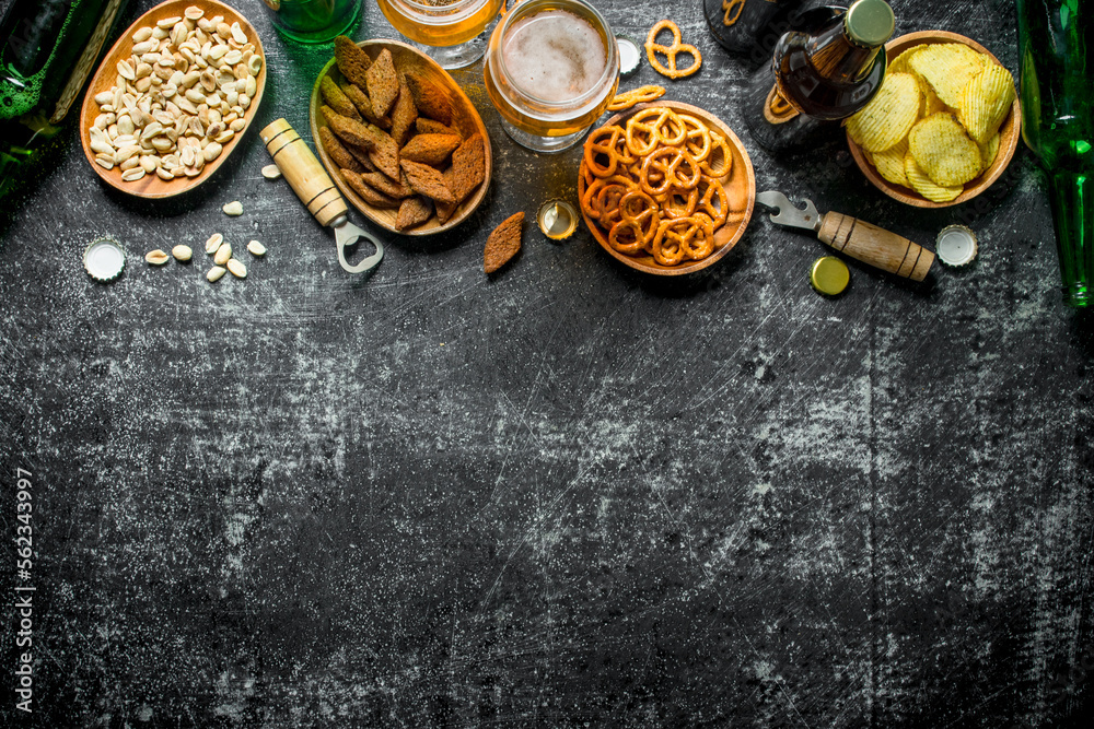 Beer and an assortment of different snacks with openers. Beer and an assortment of different snacks with openers.