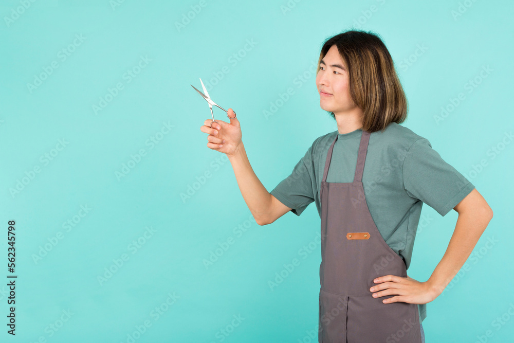 Asian hairdresser gesturing as cutting hair with a scissor Asian hairdresser gesturing as cutting hair with a scissor