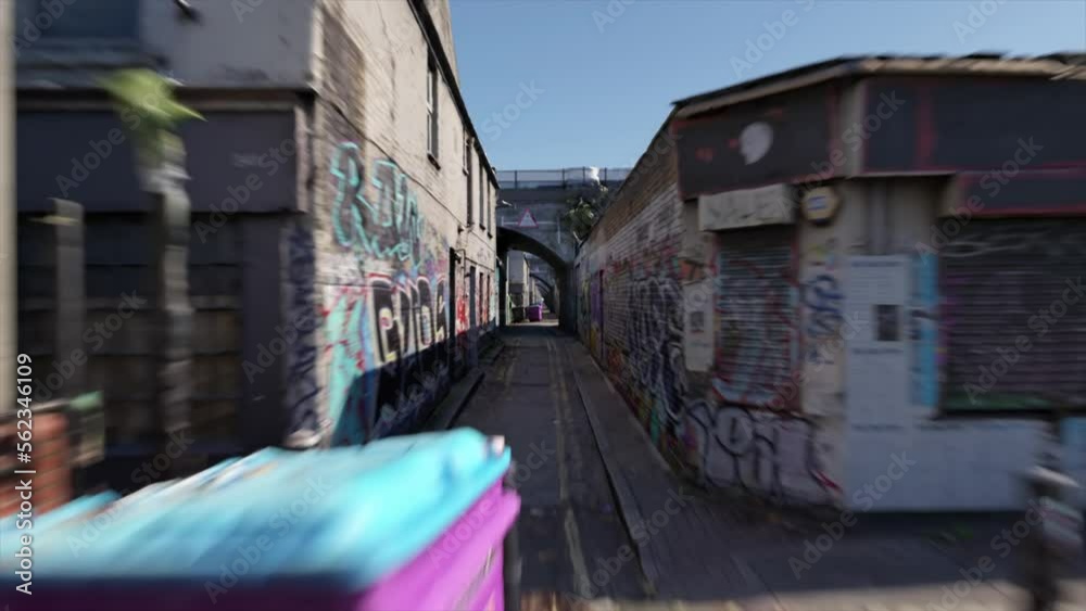 Road along an abandoned street. The windows and doors of the houses are closed. Graffiti. Clear day. Time passes quickly