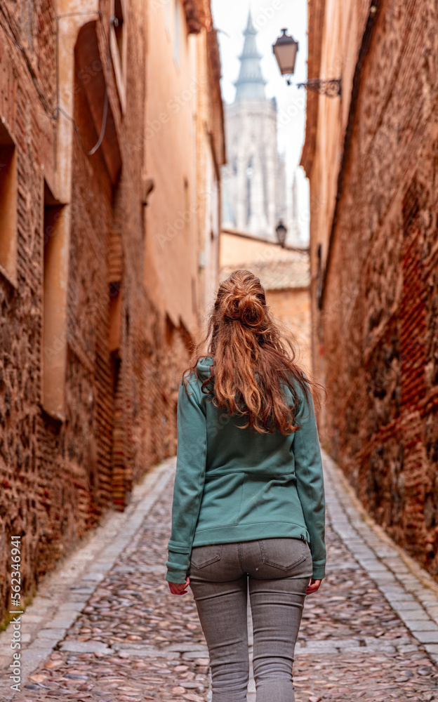 Woman tourist walking in street of Toledo in Spain