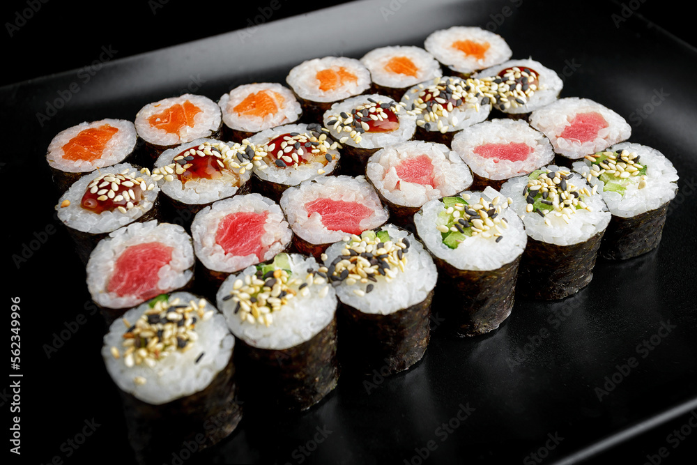 Sushi rolls in assortment on a black background Sushi rolls in assortment on a black background