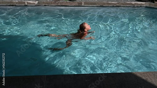 child swimming in a pool