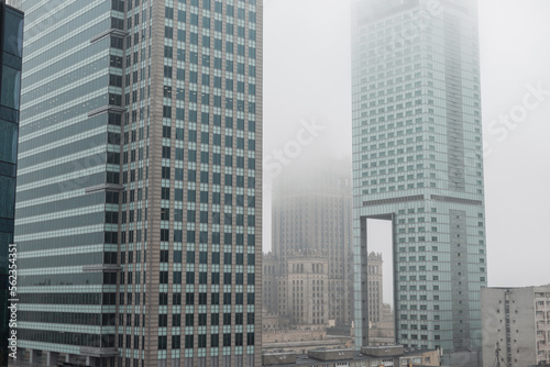 Beautiful modern metropolis in the fog with business and office buildings and the Palace of Culture in Warsaw. Amazing city of Warsaw, Poland on a cloudy, overcast day. Urban wallpaper