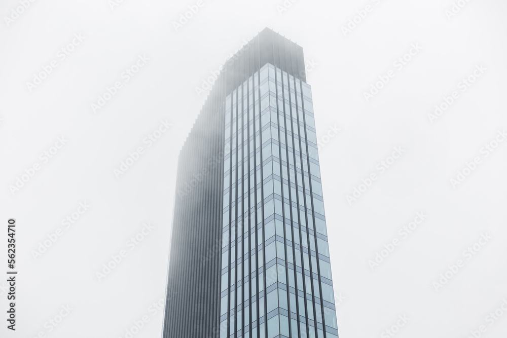 Fototapeta premium Modern business building made of glass and metal in the clouds. Beautiful modern cloudy city of Warsaw