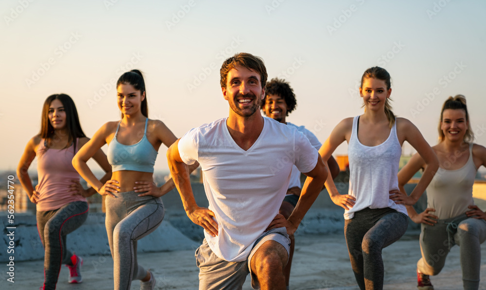 Group of happy fit people friends exercising together outdoor to stay healthy - obrazy, fototapety, plakaty 