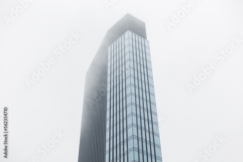 Modern business building made of glass and metal in the clouds. Beautiful modern cloudy city of Warsaw
