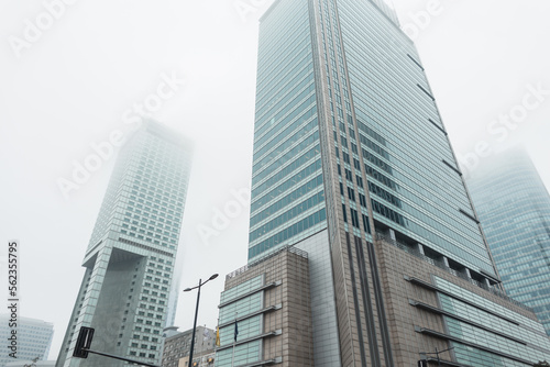 Modern city of Warsaw, Poland with office and business buildings in the fog