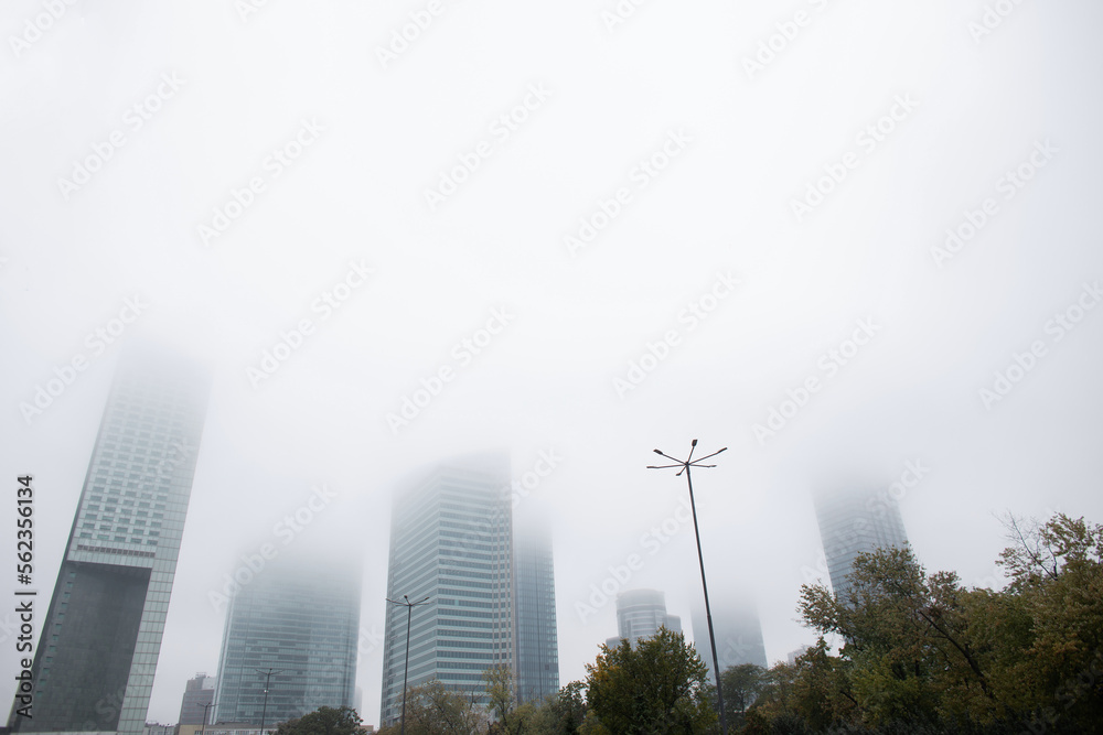 Beautiful autumn city of Warsaw, Poland with office and business buildings in the fog