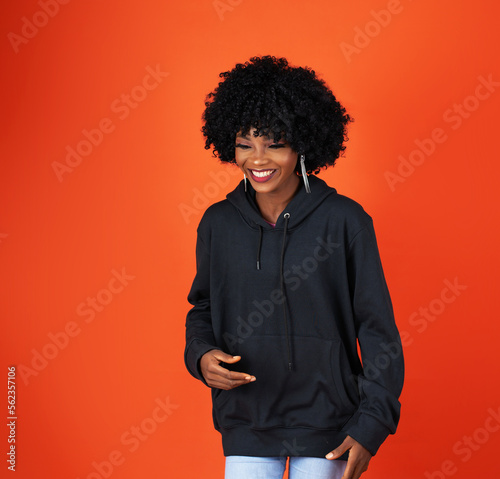 A lady on afro, wearing a black hoodie