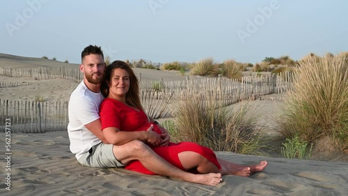 couple sitting in the sand