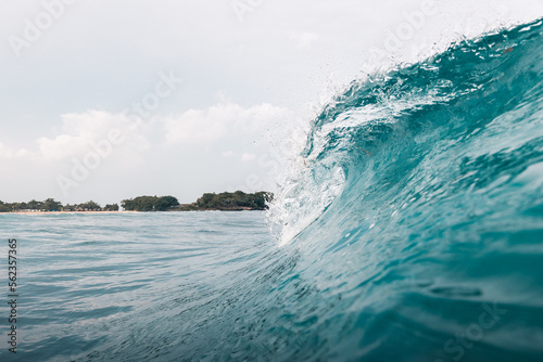 Blue wave breaking in the outside reef in Bali Indonesia