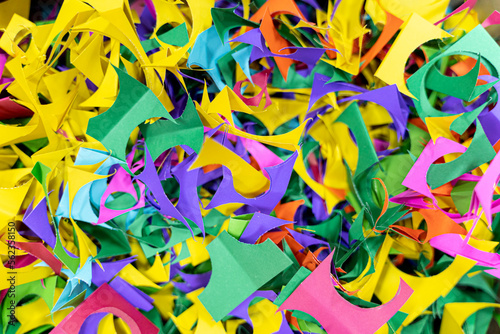 Color shredded confetti paper gift box filler. Abstract bright colored background.