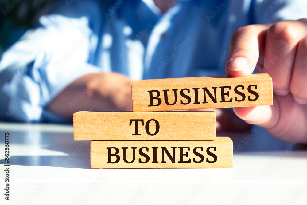 Close up on businessman holding a wooden block with Close up on businessman holding a wooden block with