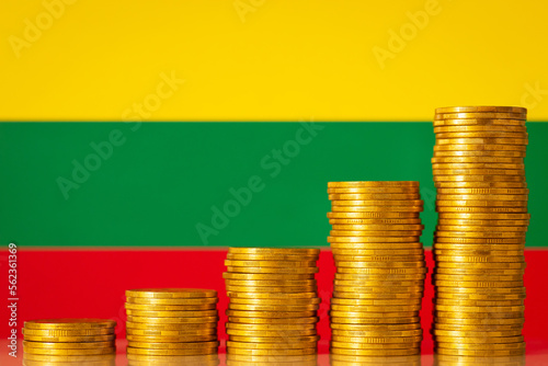 Coins forming upgoing graph near flag of Lithuania. Economic and financial growth of Lithuania