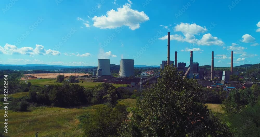 Aerial view of coal power plant high pipes with black smoke moving up polluting atmosphere at sunny day. Aerial view of coal power plant high pipes with black smoke moving up polluting atmosphere at sunny day.