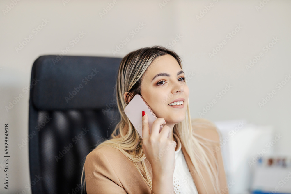 A friendly assistant is sitting at the office and taking phone calls. A friendly assistant is sitting at the office and taking phone calls.