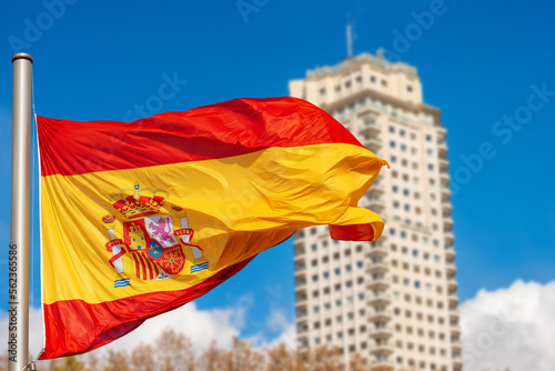 Spanish flag (la Rojigualda) blowing in the wind in Spain Square (Plaza de Espana), Madrid downtown, Spain, Europe.