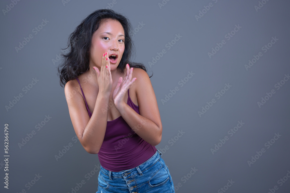 cute young asian girl in tank top with funny expression isolated from the background cute young asian girl in tank top with funny expression isolated from the background