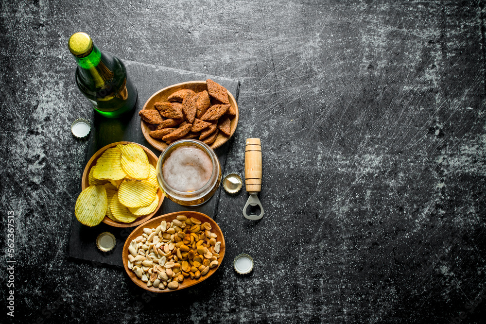 Beer and various kinds of snacks in the bowls. Beer and various kinds of snacks in the bowls.