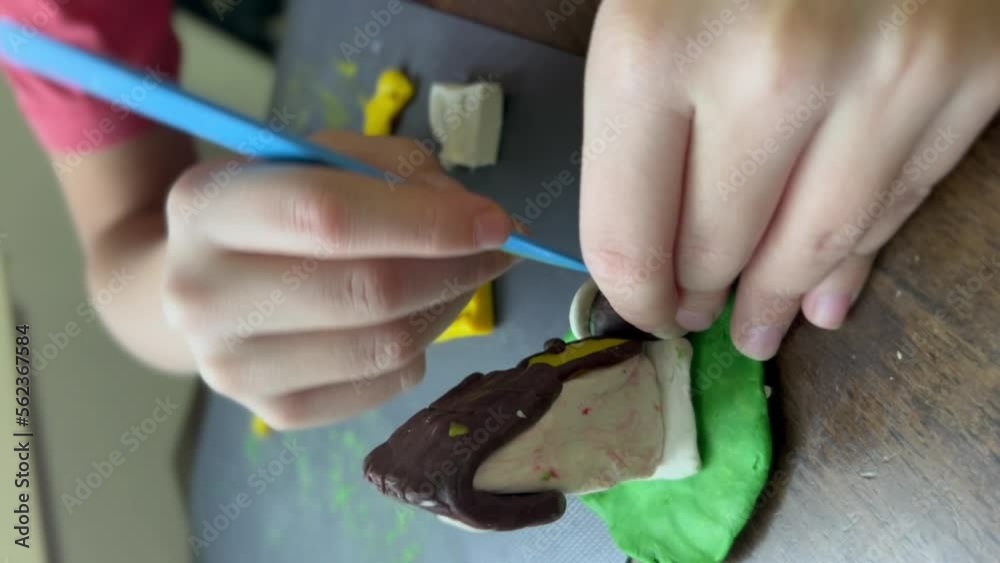 child modeling a candle using wax and molding clay tool. Boy hands close up view. High quality 4k vertical footage child modeling a candle using wax and molding clay tool. Boy hands close up view. High quality 4k vertical footage