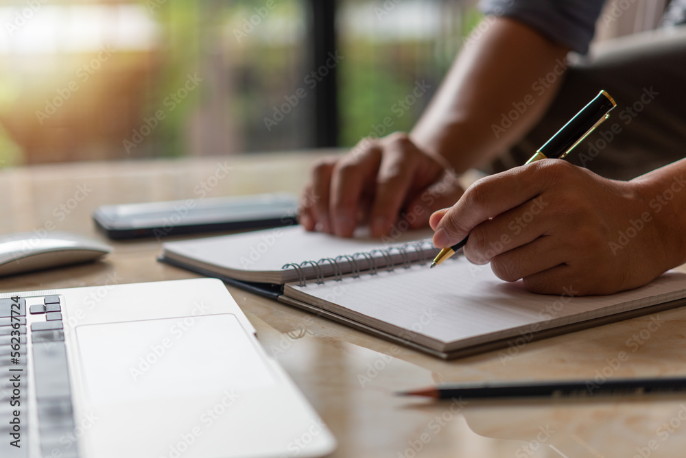 Businessperson reading and writing on book.education studying knowledge development and cognition learning concept. Businessperson reading and writing on book.education studying knowledge development and cognition learning concept.