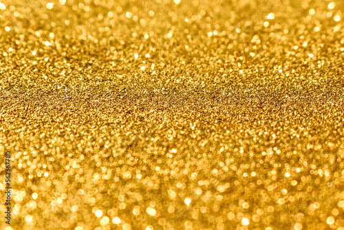 Golden yellow shiny light bokeh background. New Year, Christmas and all celebration background concept. 
