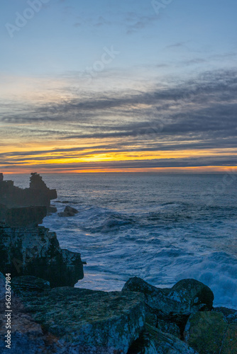 Sunset over the cliffs in Peniche, with the rough sea.