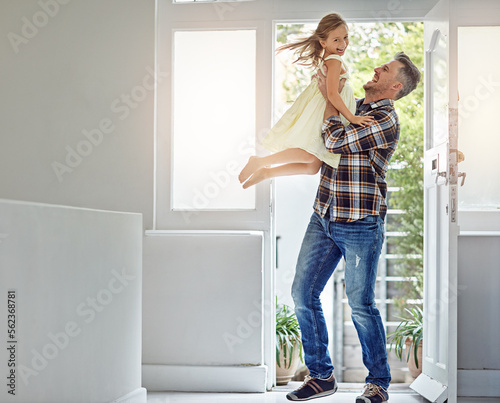 Happy, freedom and dad carrying a girl in their modern family home for fun, care and love. Smile, happiness and mature man playing and bonding with his excited daughter in their house in Australia.