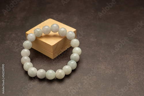 White jade bangles on a wooden cubes over a table