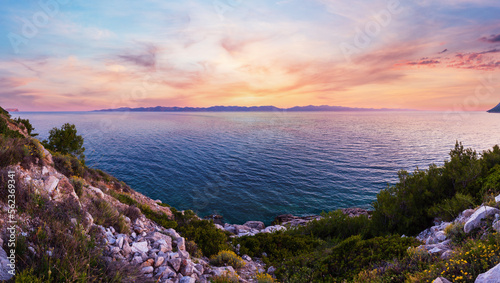 Fototapeta Naklejka Na Ścianę i Meble -  Evening summer coastline view with pink sunset and Island on horizon (Ston,  Peljesac  peninsula, Croatia)