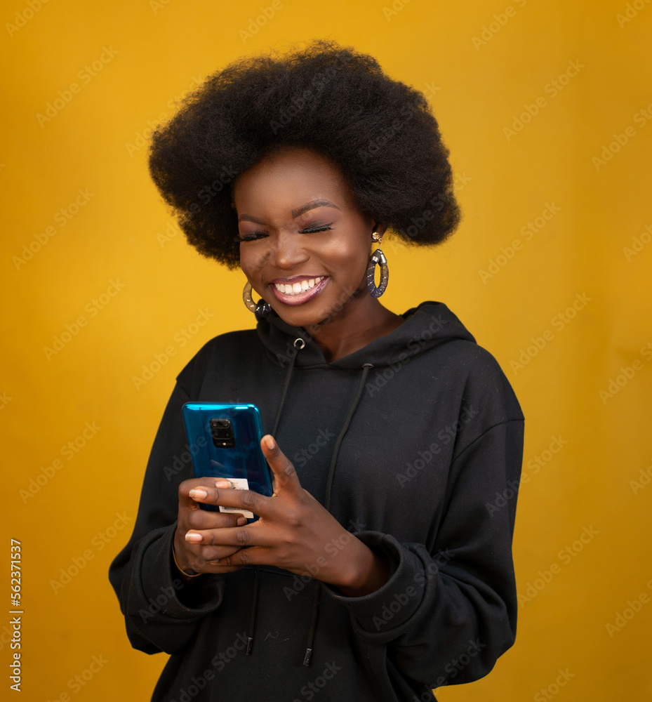Black girl holding a mobile phone Black girl holding a mobile phone
