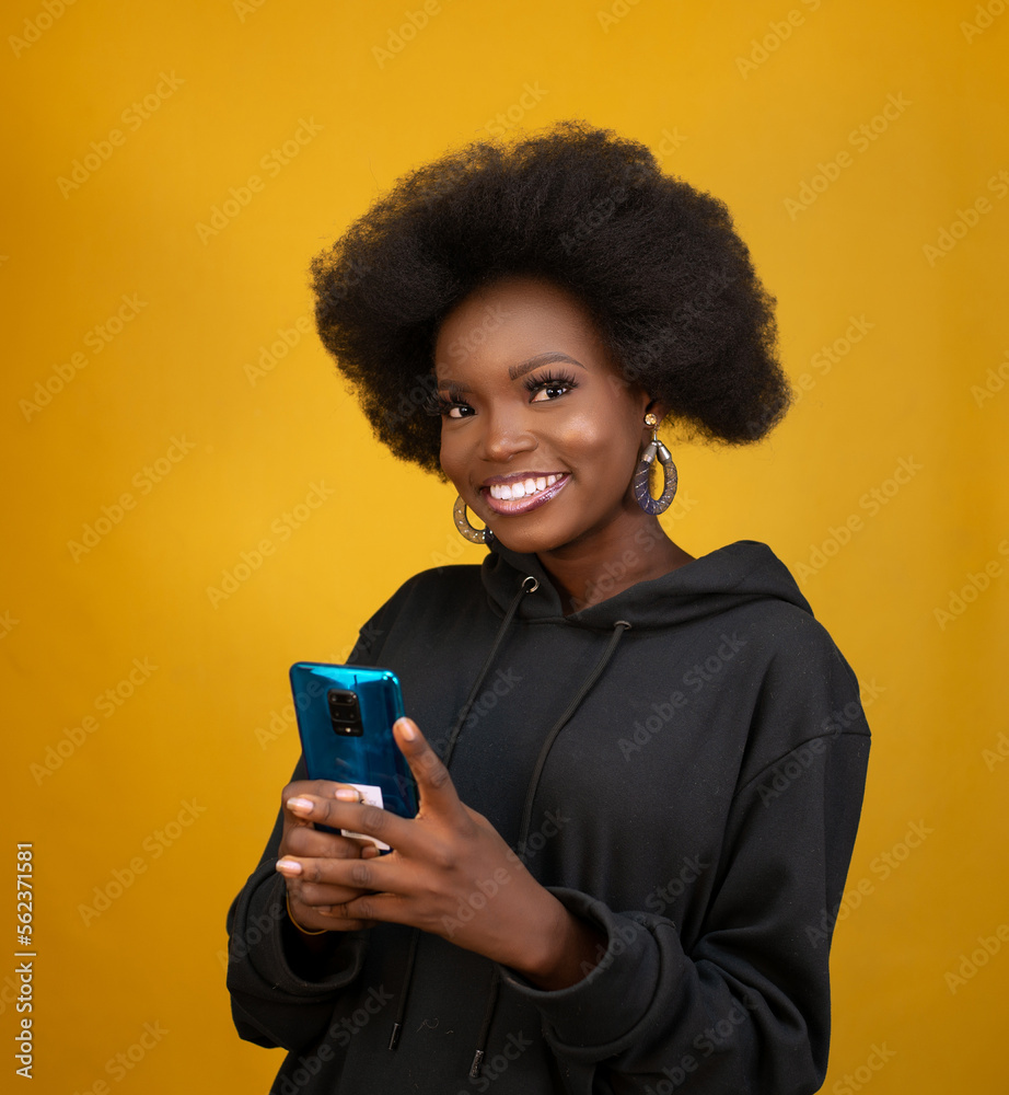 Black girl holding a mobile phone Black girl holding a mobile phone