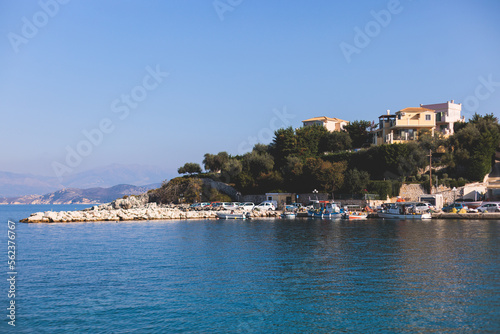 Aerial view of Kassiopi, village in northeast coast of Corfu island, Ionian Islands, Kerkyra, Greece in a summer sunny day, with marina, town, beach and castle