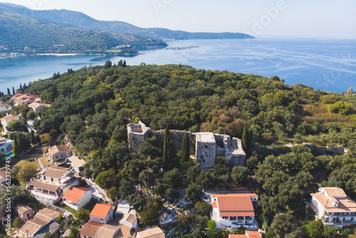 Aerial drone view of Kassiopi, village in northeast coast of Corfu island, Ionian Islands, Kerkyra, Greece in a summer sunny day, with marina, town, beach and castle © tsuguliev