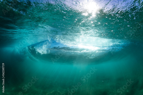 perfect wave breaking underwater in tropical water