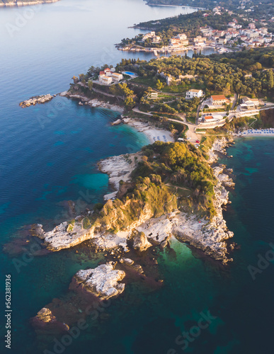 Fototapeta Naklejka Na Ścianę i Meble -  Aerial drone view of Kassiopi, village in northeast coast of Corfu island, Ionian Islands, Kerkyra, Greece in a summer sunny day, with marina, town, beach and castle