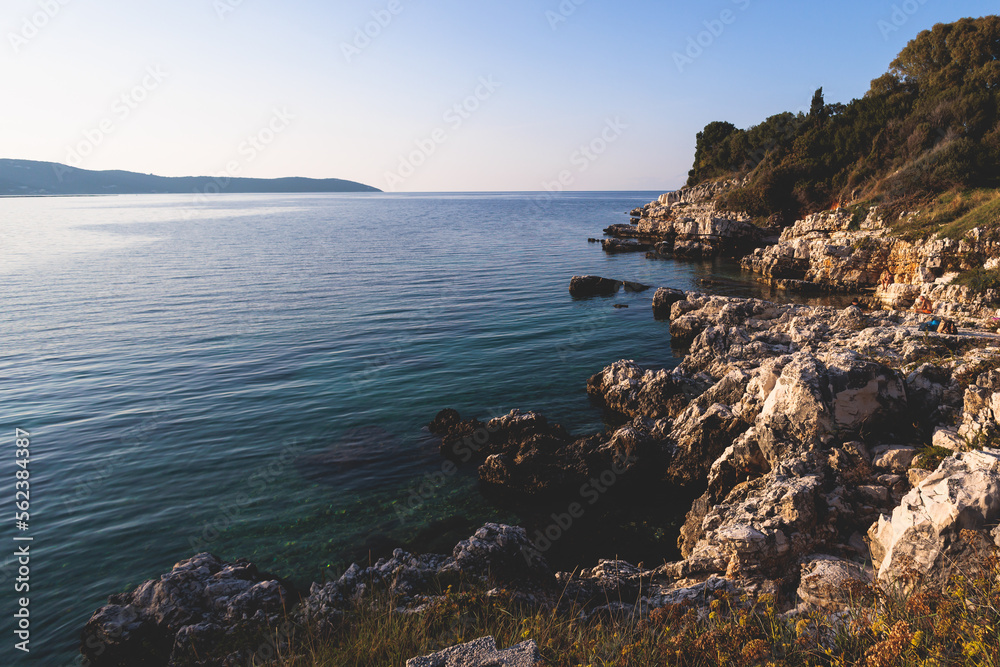 Fototapeta premium Aerial view of beach in Kassiopi village in northeast coast of Corfu island, Ionian Islands, Kerkyra, Greece in a summer sunny day