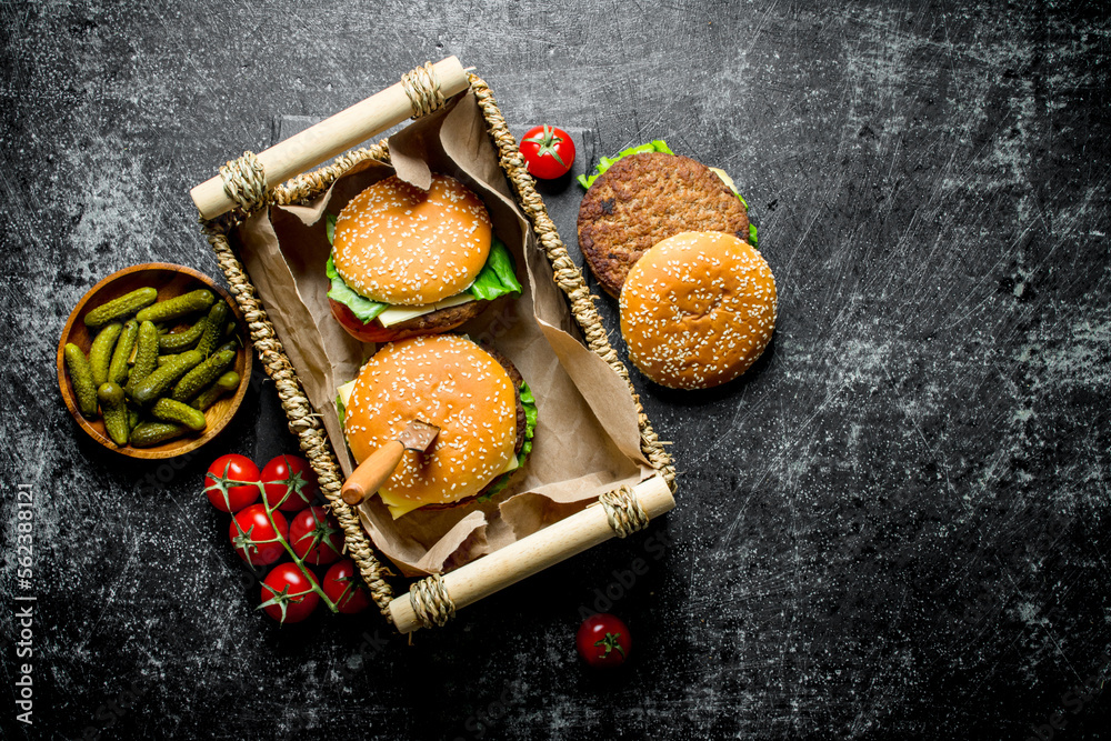 Fototapeta premium Burgers in the basket and gherkins in the bowl.