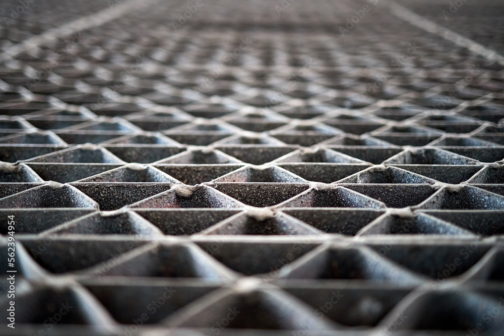 Metal industry steel grade sheet or floor grating with multicolored drops of paint macro closeup