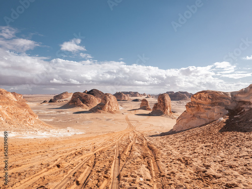 The view of car tracks in the sand of Valley of Agabat, White Desert, Egypt.
