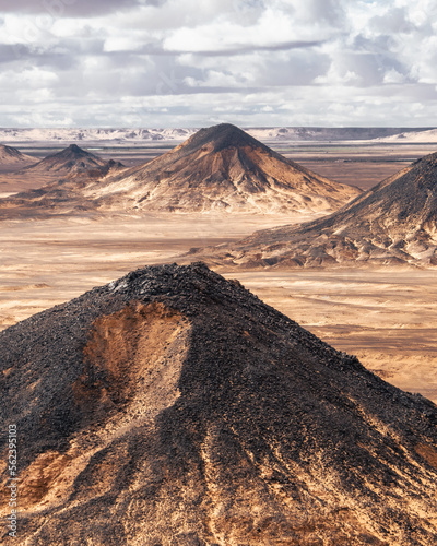 Volcanic hills and landscape in Black Desert, Egypt on  a cloudy day.