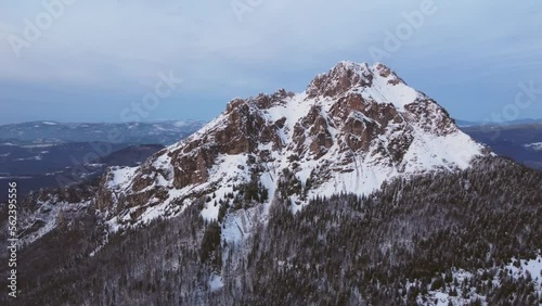 Aerial view of a majestic mountain peak at dusk .Mountaineering Existential thoughts.Winter nature photo