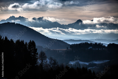 Amazing landscape of Tatra Mountains in the clouds and  moody and misty dark forest under the peaks, Poland © Przemysław Głowik
