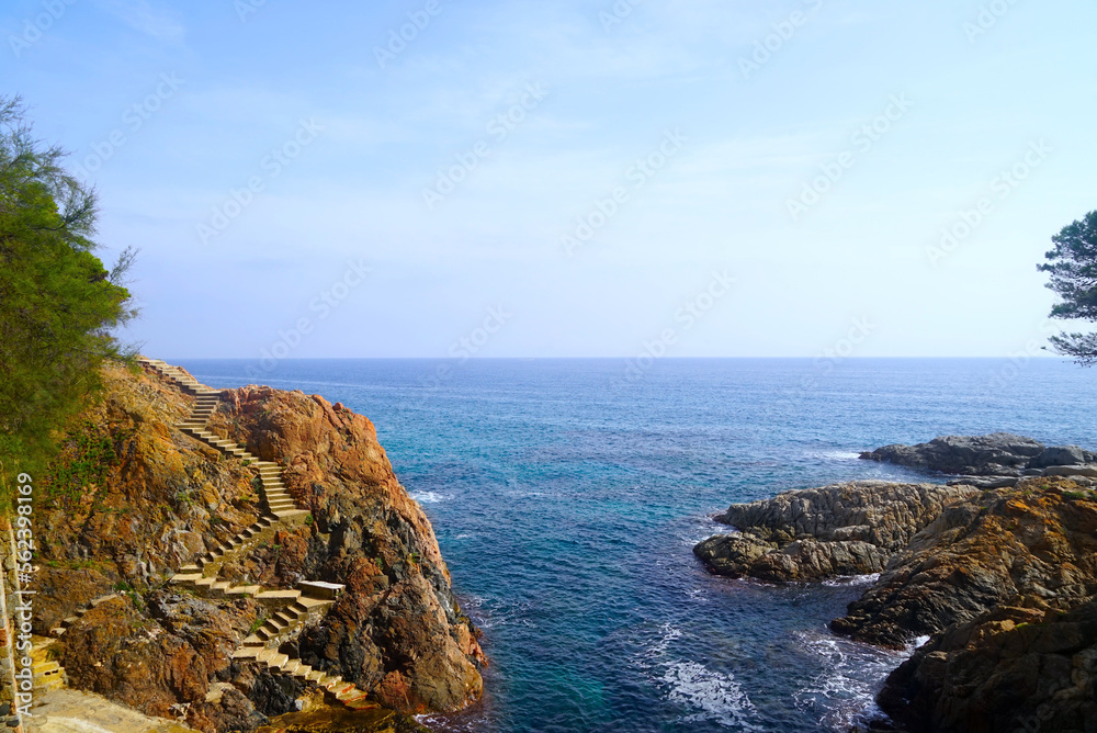 many steps lead down to the sea on a rocky coast, Costa Brava, Catalonia, Spain