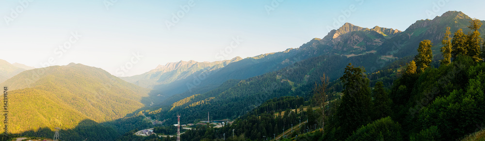 Panorama: View of the Caucasus Mountains at the Rosa Khutor resort at sunset in summer
