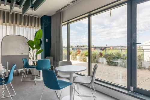 A coworking office with rest tables next to a terrace with views