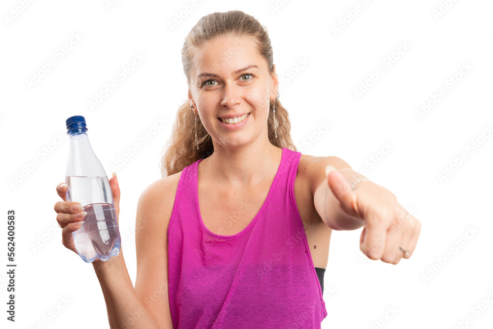 Fit smiling woman holding water bottle making thumb-up gesture Fit smiling woman holding water bottle making thumb-up gesture