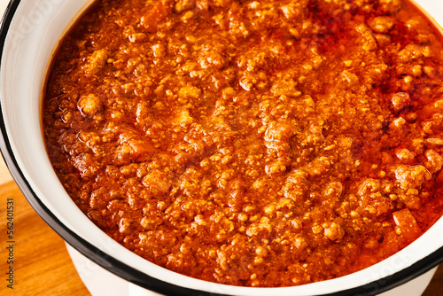 Close-up of fresh BOLOGNESE SAUCE in a white saucepan. High angle view. photo